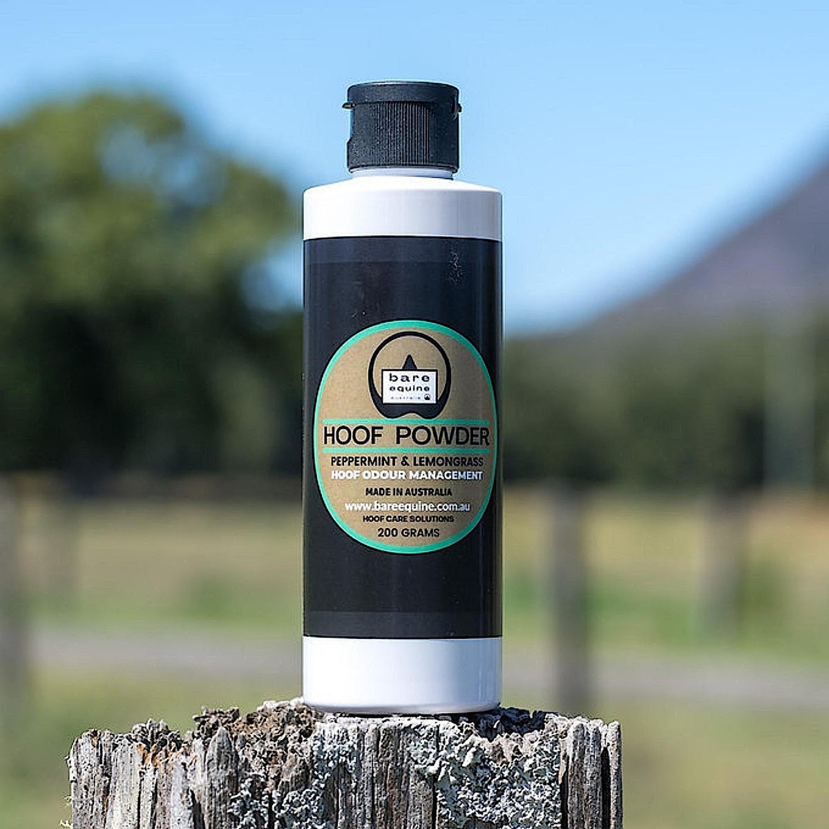 White cylindrical bottle of hoof powder with black lid and label.