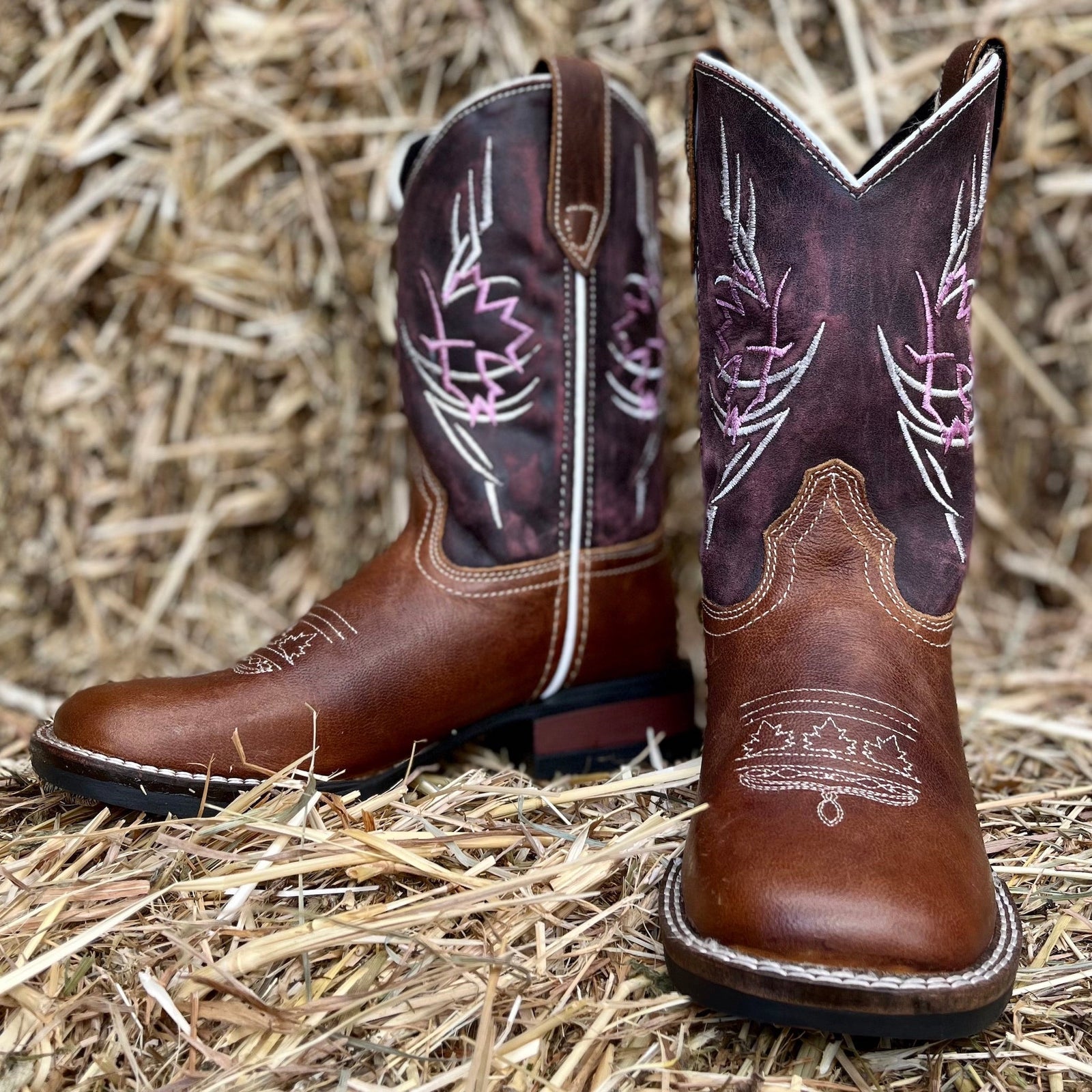 Brown boots with white and pink stitch detailing and deep rose upper boot
